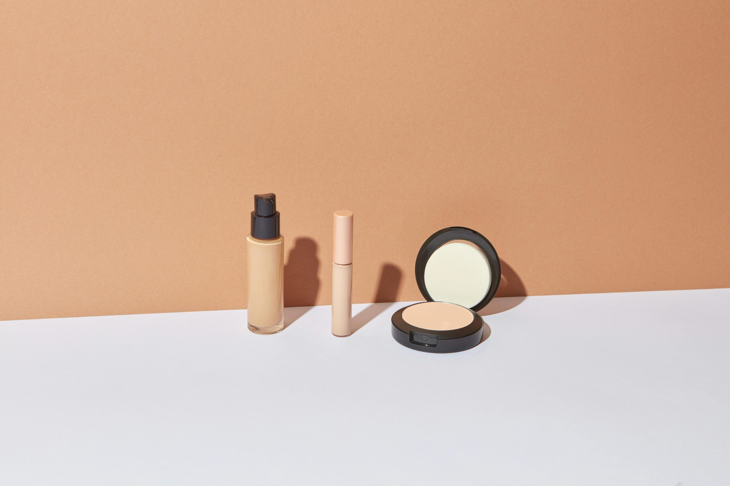 Three cosmetic items displayed against a neutral background for elegant product photography.