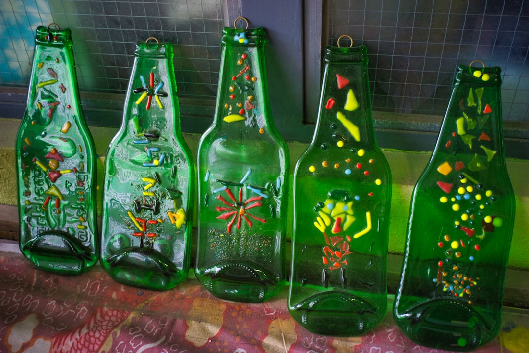 Screen printing process on glass dropper bottles at a cosmetic packaging production facility