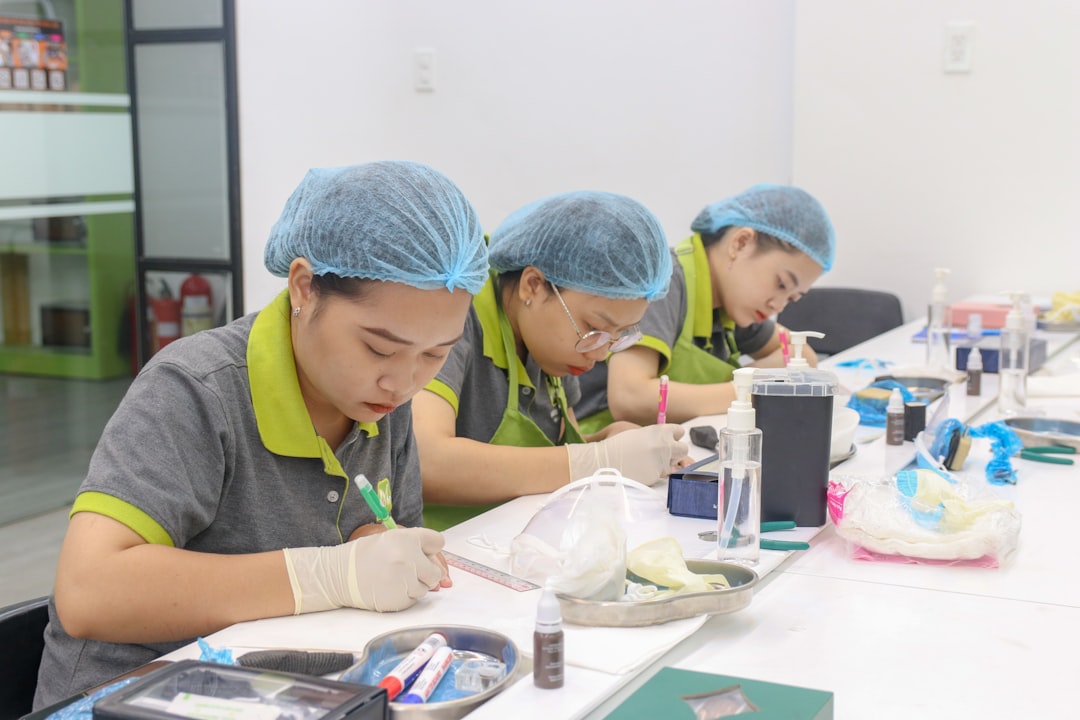 Quality control inspector examining cosmetic packaging samples with measurement tools in factory setting