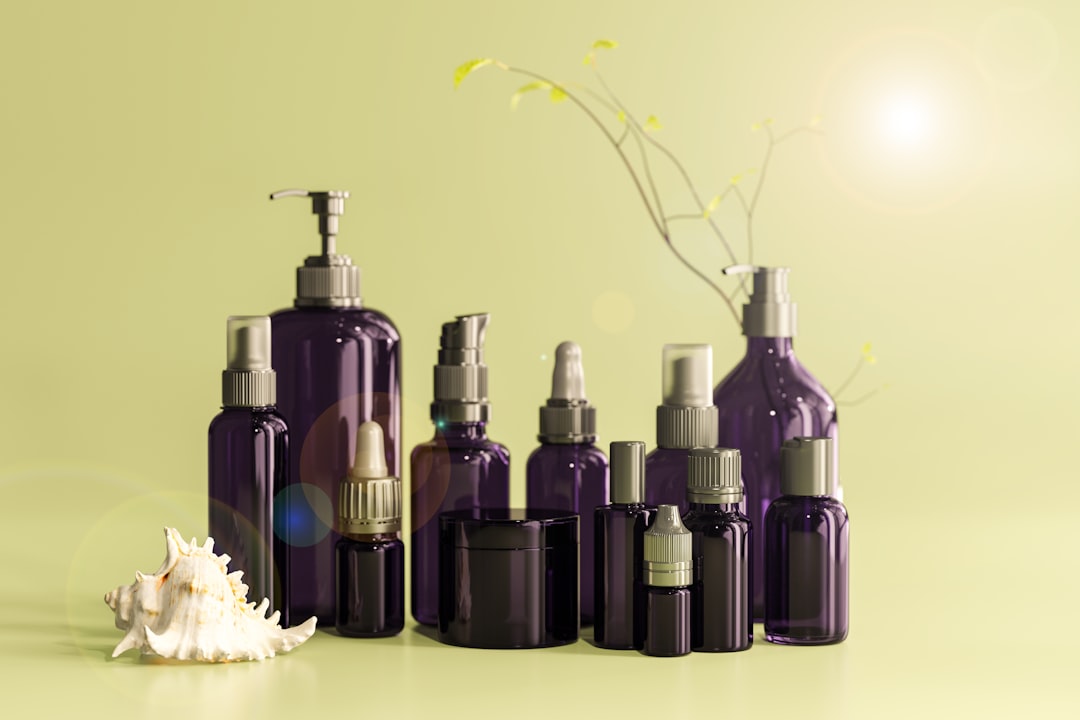 Row of cosmetic bottles with lotion pump dispensers in various sizes for skincare products