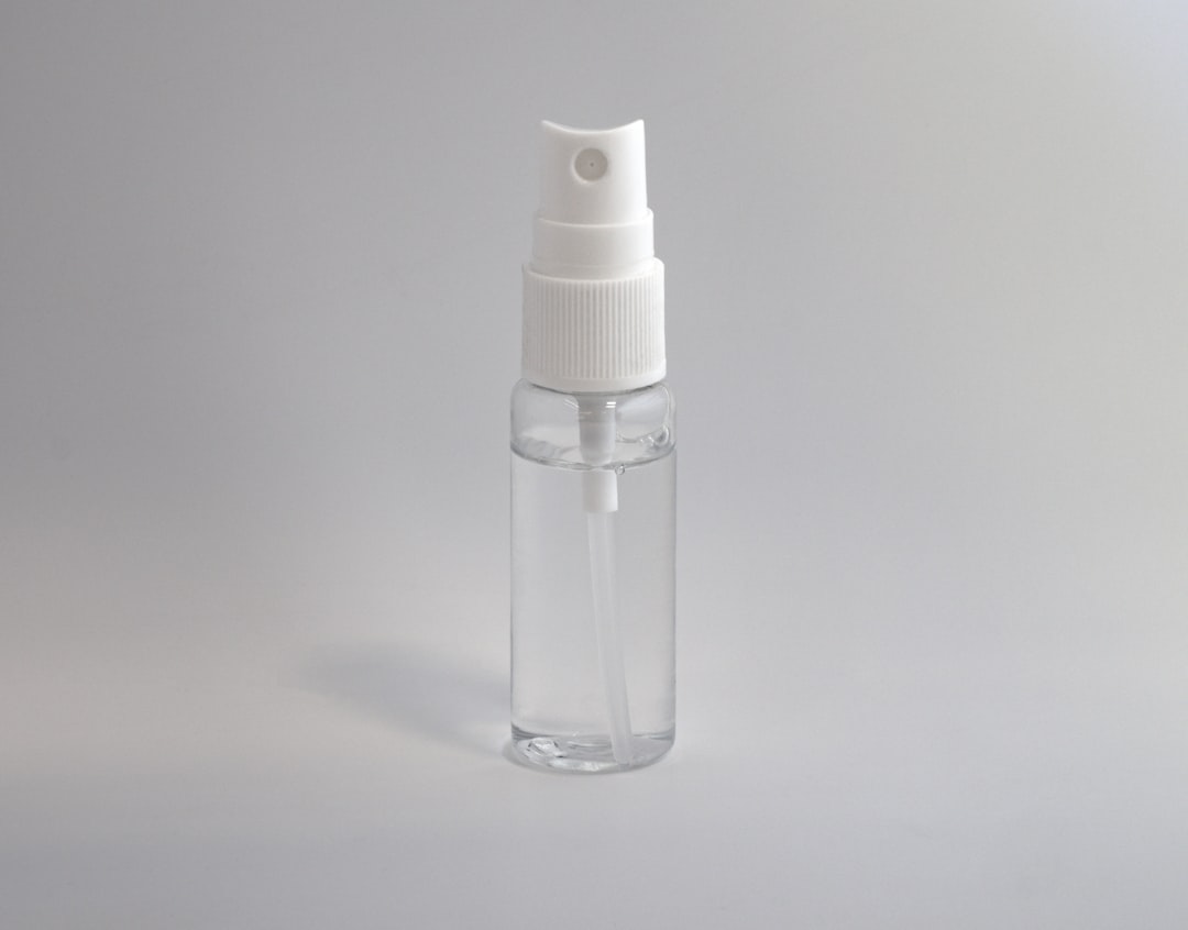 Glass dropper pipette tube dispensing serum drops showing precise drop formation