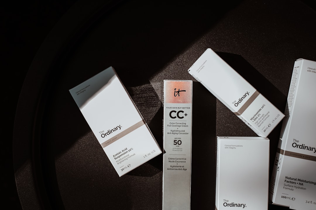 Quality control inspector checking airless pump bottle actuation and seal integrity on a cosmetic packaging production line